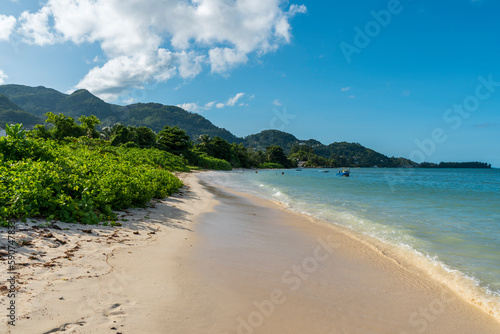Seychelles Mahe beaches offer a range of benefits and attractions that make them a desirable destination for many travelers. beautiful sea on a sunny day and cloudy sky