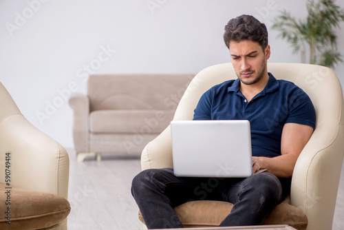 Young male freelancer working from home © Elnur