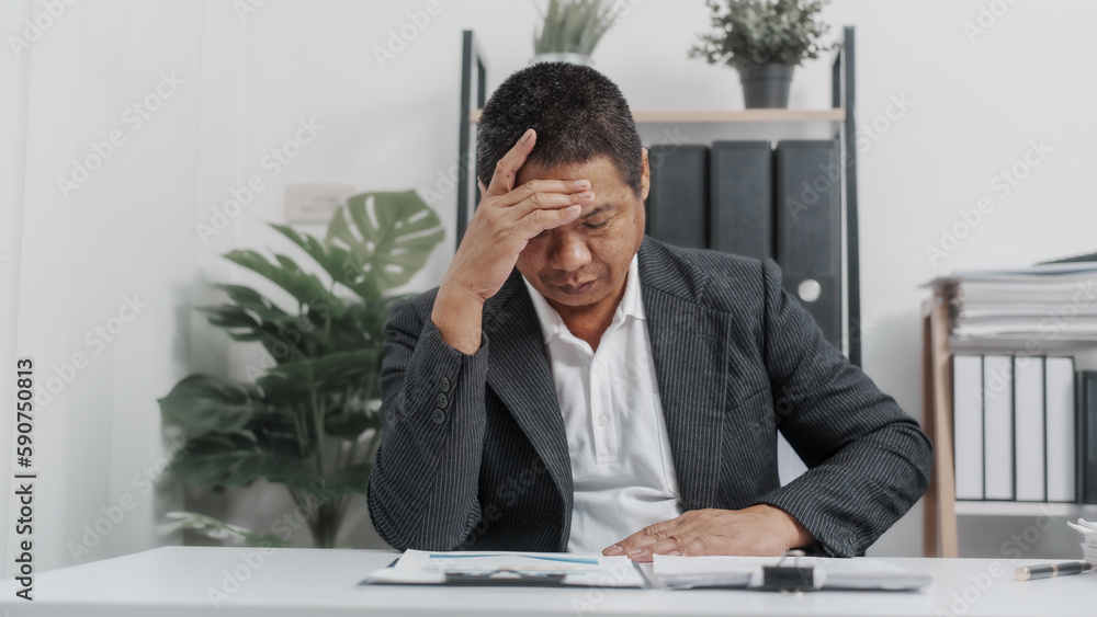 Tired, Elderly Old Senior Asian male businessman wearing formal suit ,confident professional bookkeeper doing bookkeeping, lawyer, stock market trader or broker. Tired, Elderly Old Senior Asian male businessman wearing formal suit ,confident professional bookkeeper doing bookkeeping, lawyer, stock market trader or broker.