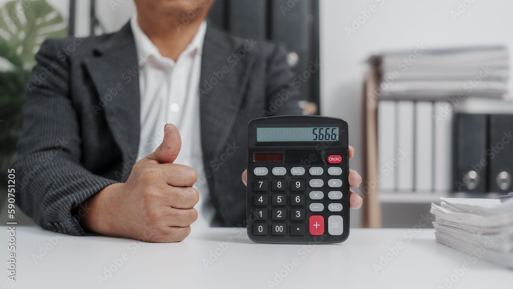 Using, calculator, Elderly Old Senior Asian male businessman wearing formal suit ,confident professional bookkeeper doing bookkeeping, lawyer, stock market trader or broker. Using, calculator, Elderly Old Senior Asian male businessman wearing formal suit ,confident professional bookkeeper doing bookkeeping, lawyer, stock market trader or broker.
