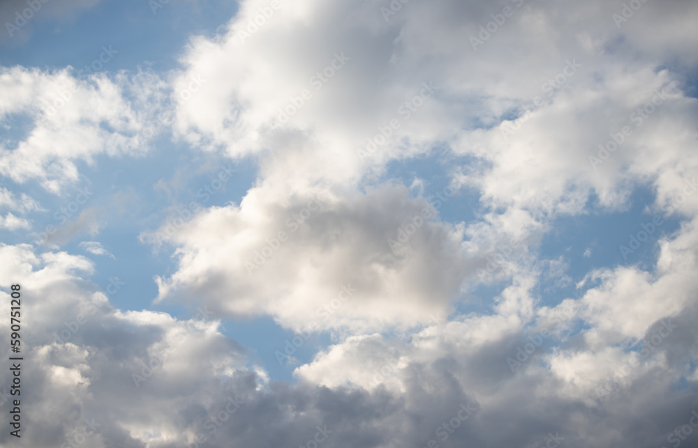 Blue sky with white fluffy clouds in sunny weather. Blue sky with white fluffy clouds in sunny weather.