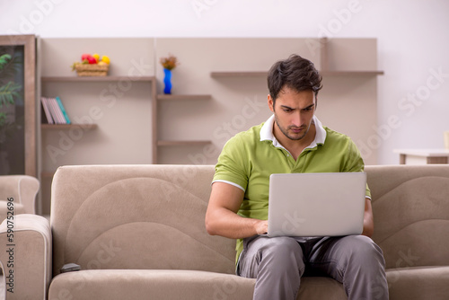 Young male freelancer working from home © Elnur