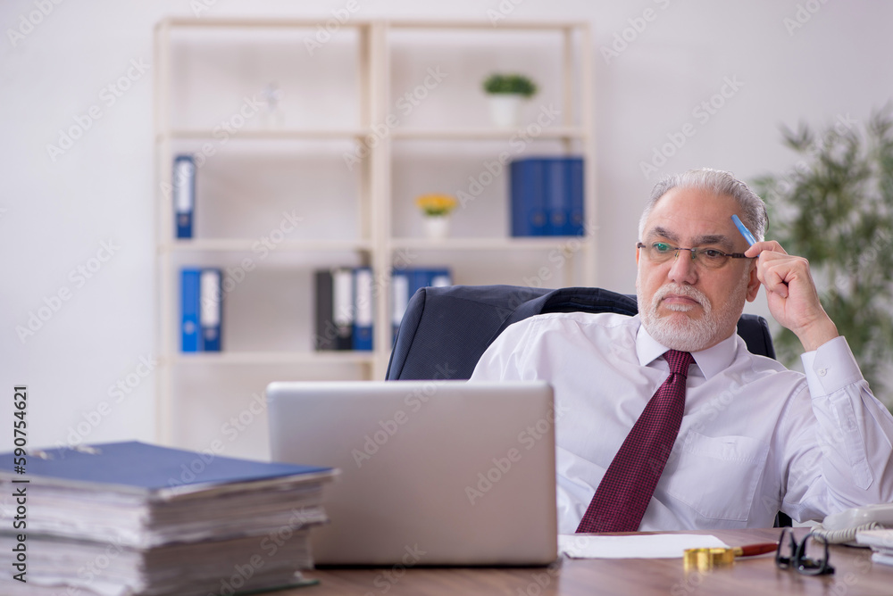 Old male employee and too much work in the office Old male employee and too much work in the office