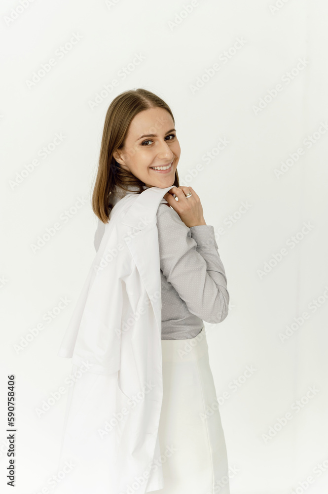 portrait of a joyful dermatologist doctor with a white coat on a white background. girl specialist in the medical field portrait of a joyful dermatologist doctor with a white coat on a white background. girl specialist in the medical field