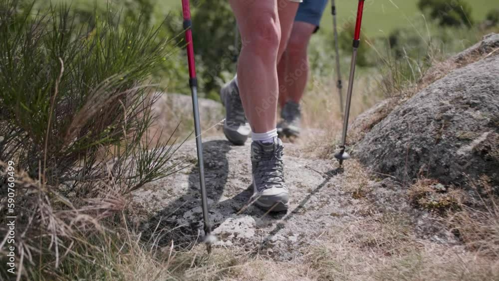 Slow motion view of an older caucasian couple's feet as they hike through the beautiful landscape Slow motion view of an older caucasian couple's feet as they hike through the beautiful landscape