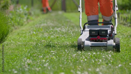 Wallpaper Mural Lawnmower corporate worker handling the grass nature, slow motion shot Torontodigital.ca