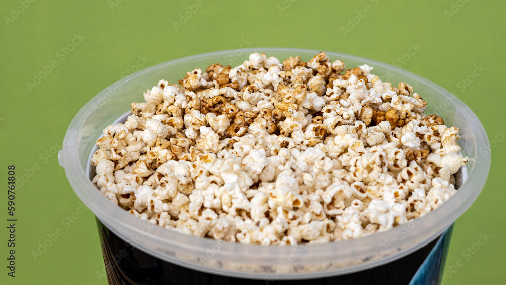 A close-up view of the background from the side, lots of popcorn, a popular crunchy food. A close-up view of the background from the side, lots of popcorn, a popular crunchy food.
