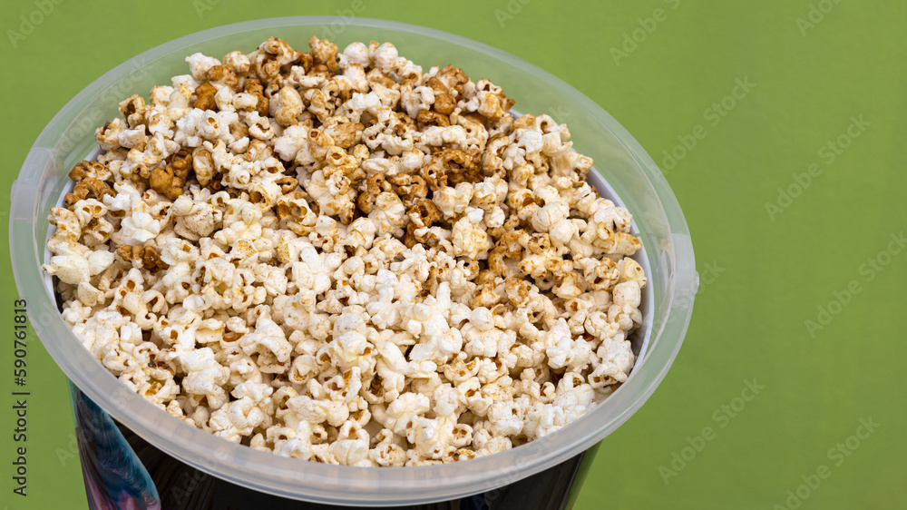 A close-up view of the background from the side, lots of popcorn, a popular crunchy food. A close-up view of the background from the side, lots of popcorn, a popular crunchy food.