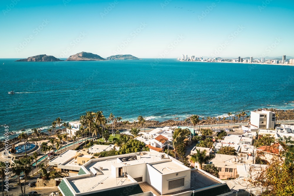 Aerial shot of a sea and buildings in Mazatlan with modern coastal buildings, Mexico