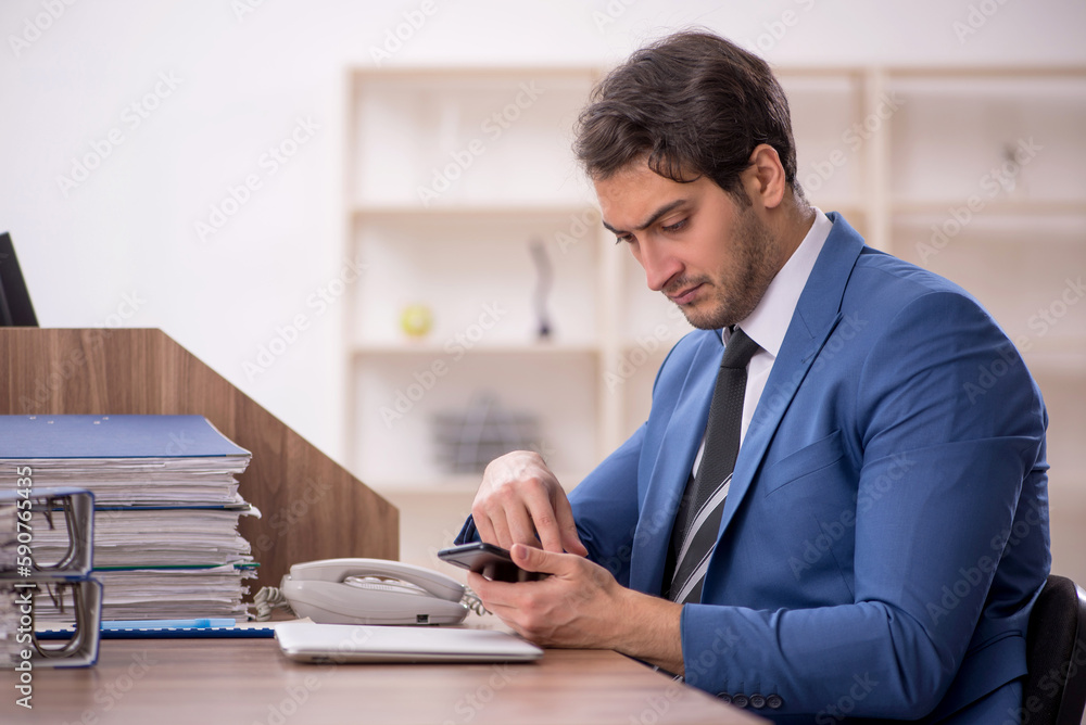 Young male employee working in the office Young male employee working in the office