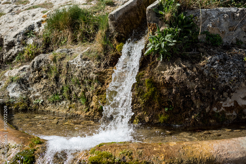Water splashes in the air on a dark background. Shallow depth of field Water splashes in the air on a dark background. Shallow depth of field