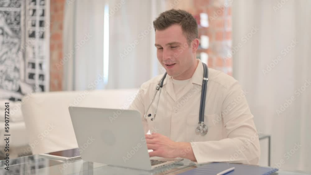 Online Video Chat by Male Doctor on Laptop in Clinic Online Video Chat by Male Doctor on Laptop in Clinic