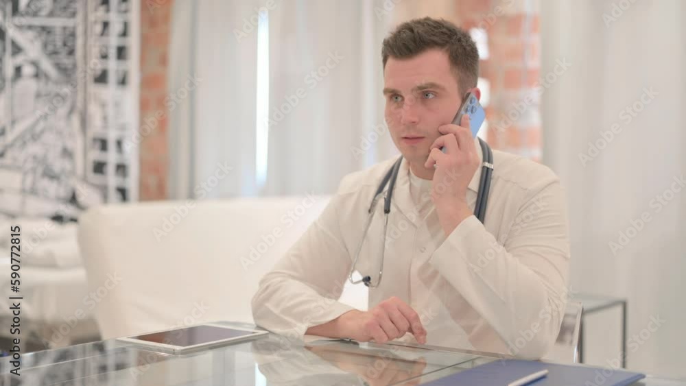 Male Doctor Talking on Phone in Clinic Male Doctor Talking on Phone in Clinic