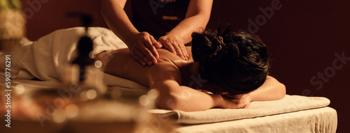 Relaxation woman back massage with masseur in cosmetology spa centre.