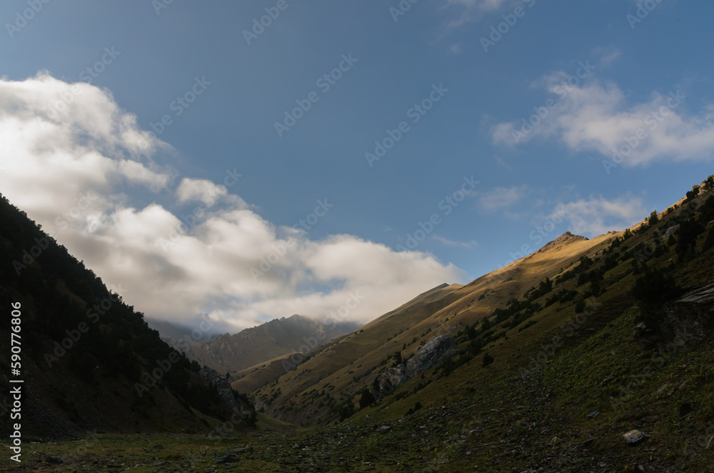 A panoramic view of a valley in the Turkestan Mountains in Kyrgyzstan.