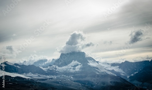 Scenic shot of a Mountain with the clouds on its peak in the shape of a hat, cool for background