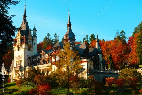 Beautiful Peles Castle (Castelul Peles) in Sinaia, Romania with autumn trees