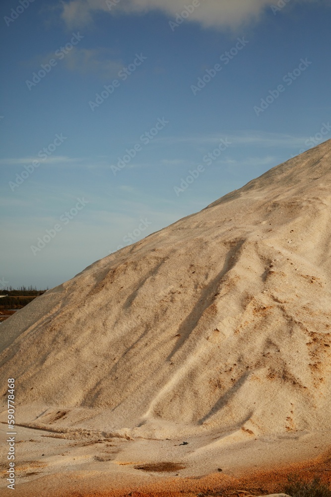 Vertical shot of Faro salt flats where sea salt is made and harvested in a rural area Vertical shot of Faro salt flats where sea salt is made and harvested in a rural area