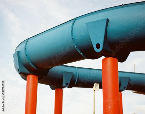 Closeup shot of a bright colour waterslide in the background of sky photo