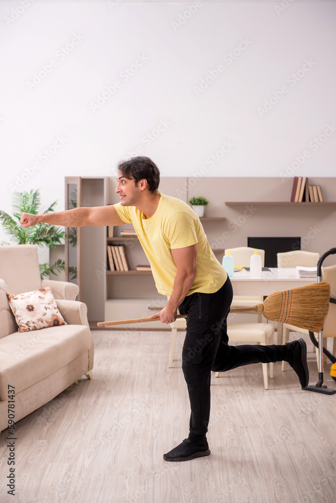 Young man doing housework indoors Young man doing housework indoors