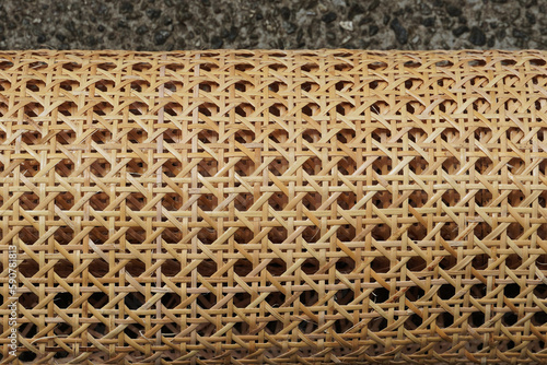 Top view of a roll of open mesh pre-woven cane (cane webbing).    