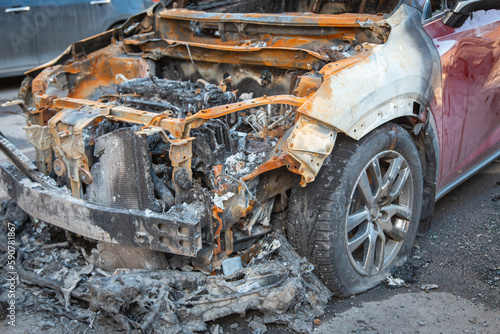 Abandoned burnt-out car after the explosion, ready for scrapping. The burnt-out interior of the car, a close-up of the fire, extinguishing the fire. A burnt-out car, due to a short circuit, arson. 