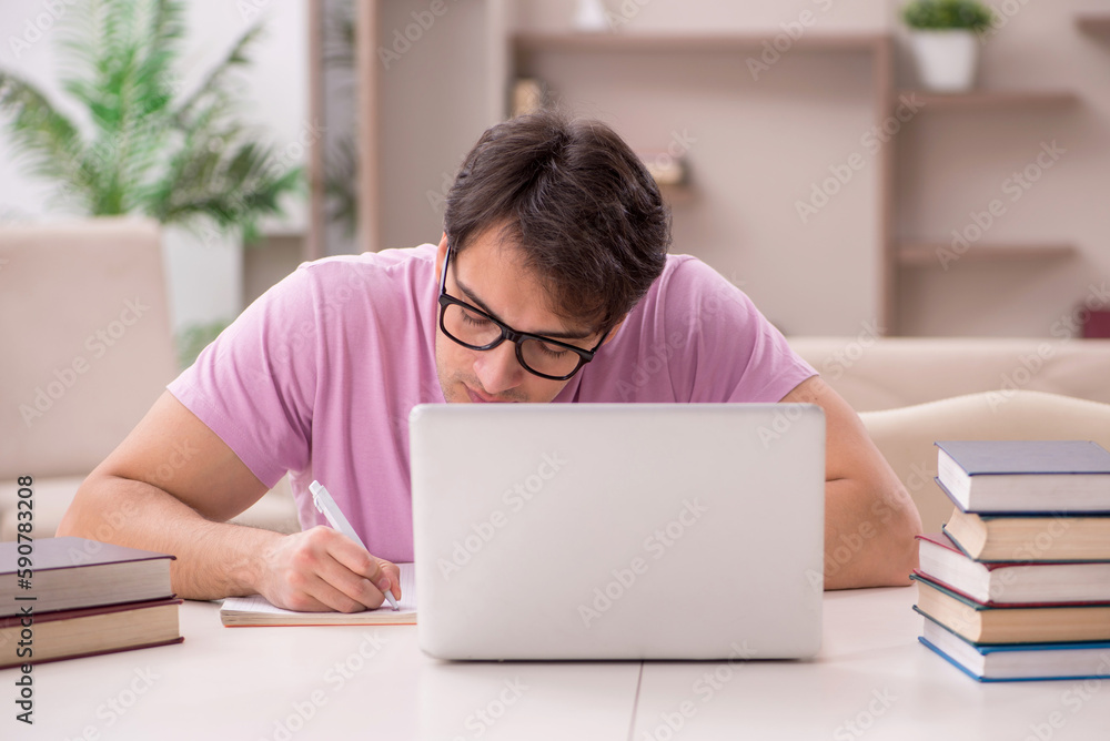 Young male student preparing for exams at home Young male student preparing for exams at home