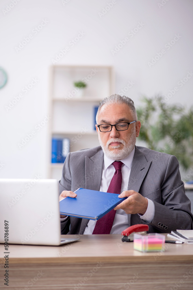 Old male employee and too much work in the office Old male employee and too much work in the office