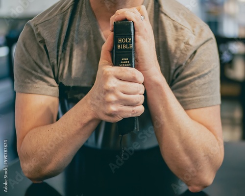 closeup of man holding Bible up with both hands while praying or worshipping Fototapet