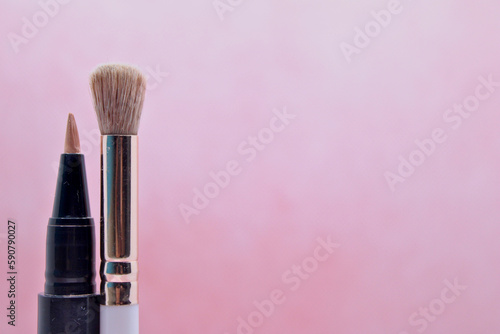 makeup products on pink background