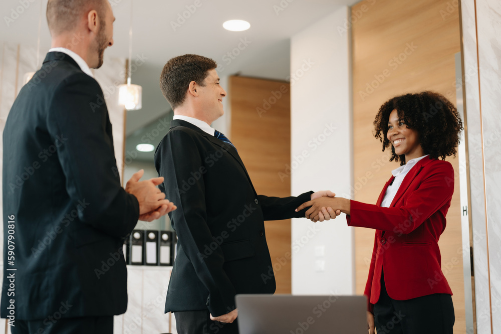 business people shaking hands during a meeting in modern office business people shaking hands during a meeting in modern office