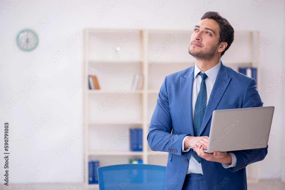 Young male employee working in the office Young male employee working in the office
