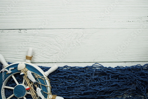 Nautical ornaments Antique sail boat Toy model and lifebuoy on wooden background photo