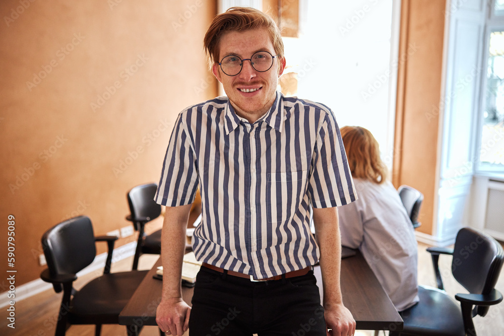 Smiling businessman standing in a boardroom Smiling businessman standing in a boardroom