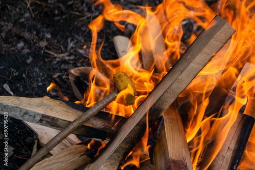 A fire burns in a campfire with a red fire in the background. High quality photo photo