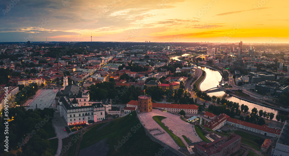 Aerial dramatic view Gediminas old castle tower in Old Town and Vilnius city panorama background, capital city of Lithuania. Scenic landmarks and sightseeing in eastern europe. Travel Lithuania concep