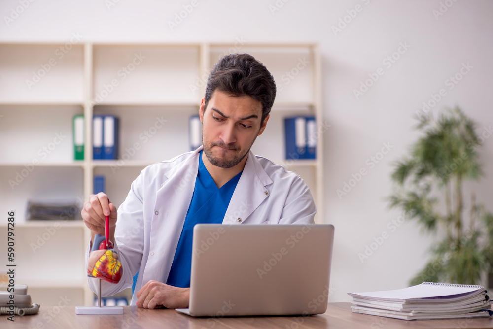 Young male doctor cardiologist working in the clinic Young male doctor cardiologist working in the clinic