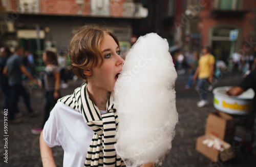 Teen girl with cotton candy on the street.