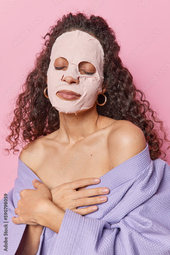 Foto de Photo of dark haired relaxed young woman keeps eyes closed