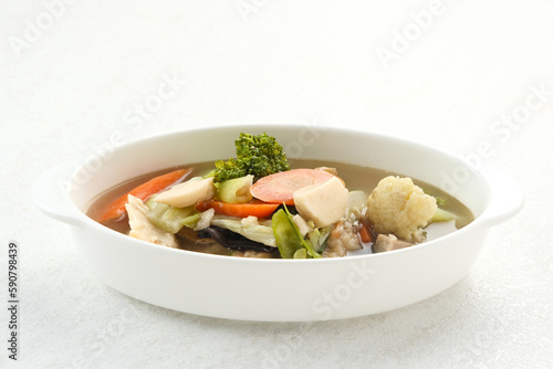 Capcay, stir fried vegetables with shrimp, meatballs and chicken. Served in white plate 