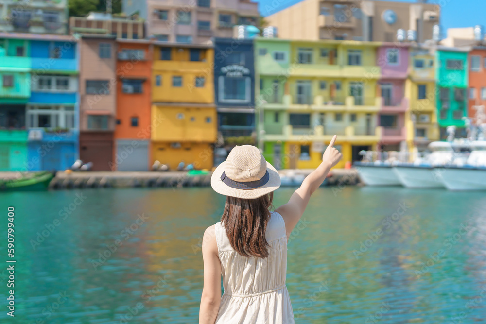 woman traveler visiting in Taiwan, Tourist with hat sightseeing in Keelung, Colorful Zhengbin Fishing Port, landmark and popular attractions near Taipei city . Asia Travel concept