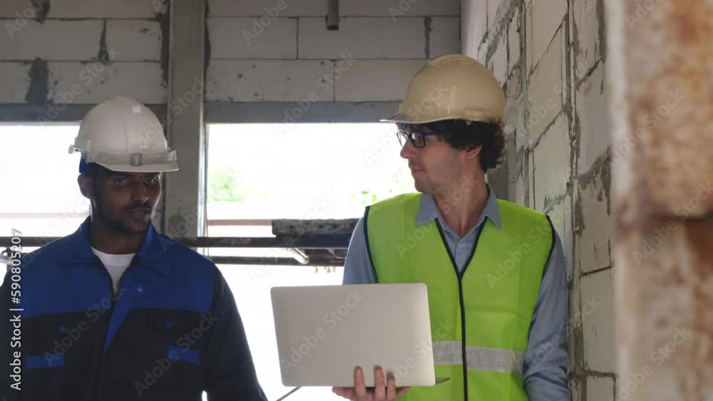 Builders and supervisor architects are walking and discussing the progress of the building's construction. Builders and supervisor architects are walking and discussing the progress of the building's construction.