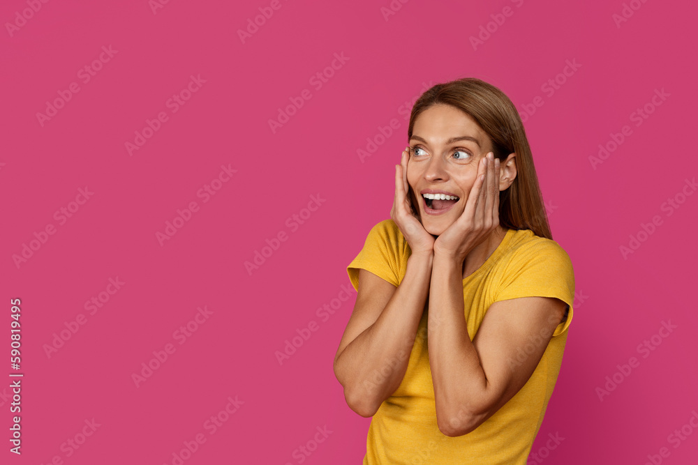 Amazed happy shocked middle aged european blonde female with open mouth looking at free space Amazed happy shocked middle aged european blonde female with open mouth looking at free space