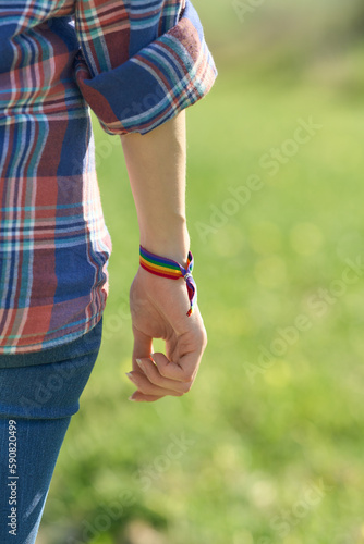 Close up rear view arm person with LGTB rainbow GAY wristband