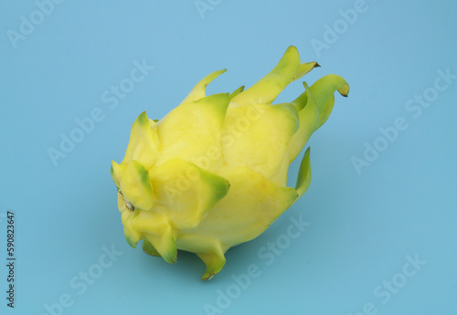 Yellow pitaya fruit on blue background 