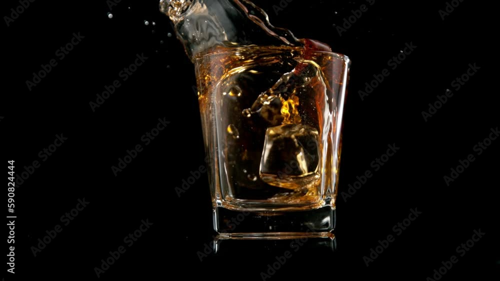 Super slow motion of pouring whiskey into glass. Filmed on high speed cinema camera, 1000 fps. Super slow motion of pouring whiskey into glass. Filmed on high speed cinema camera, 1000 fps.