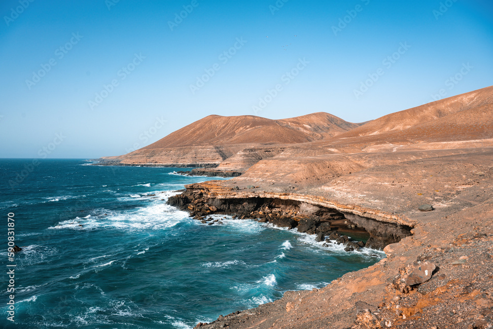 Stunning view of a rocky coastline bathed by a beautiful blue ocean. Playa del Aguila (Eagles' Beach) Fuerteventura, Canary Islands, Spain...