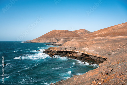 Obraz na płótnie Stunning view of a rocky coastline bathed by a beautiful blue ocean. Playa del Aguila (Eagles' Beach) Fuerteventura, Canary Islands, Spain... w salonie
