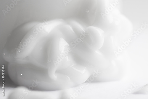 Volumetric smear of cosmetic cream on a light gray background. Beauty product for skin care and moisturizing.