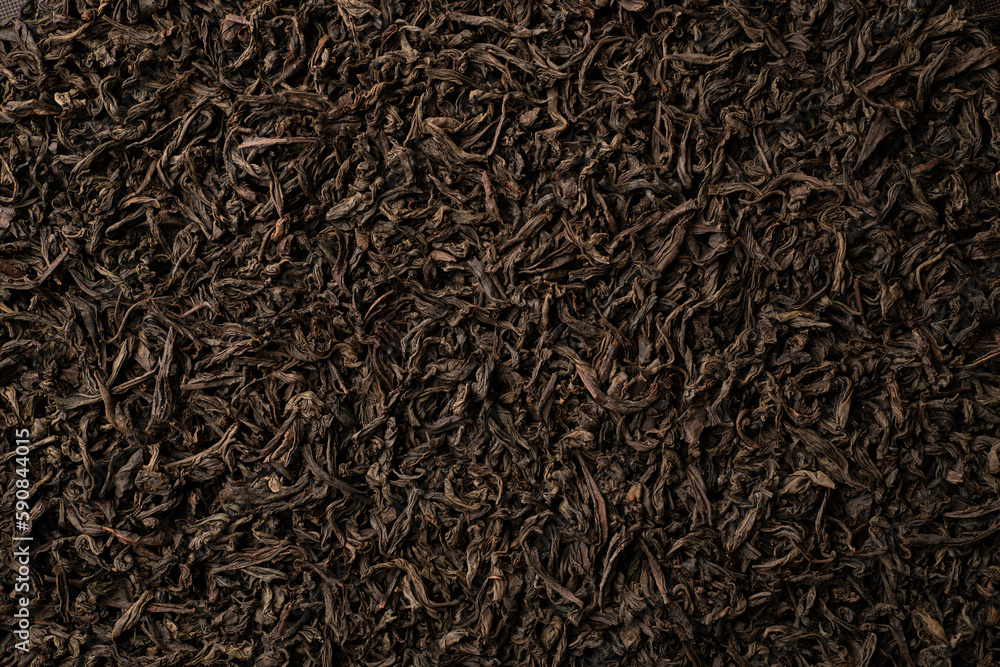 Background of black loose-leaf tea. Close up, top view Background of black loose-leaf tea. Close up, top view
